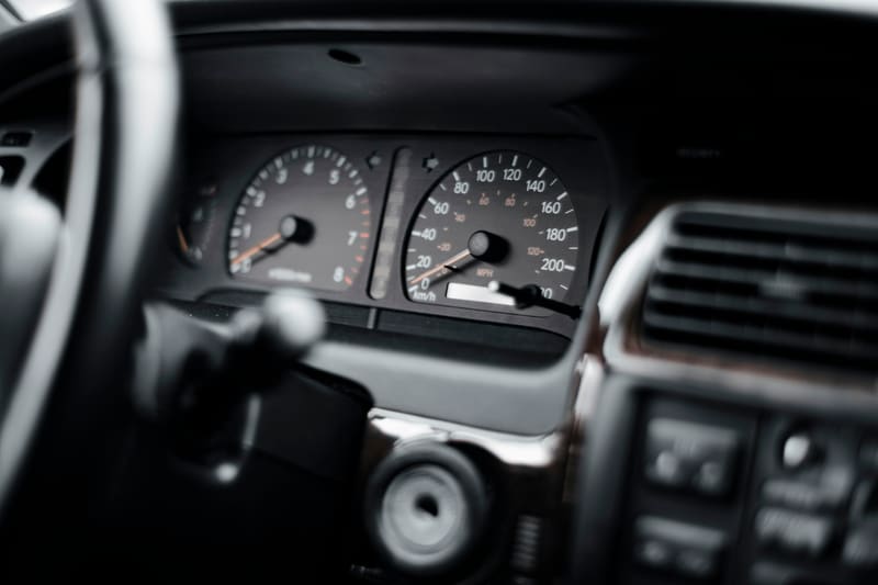 The tachometer and speedometer, seen past the rim of the steering wheel.