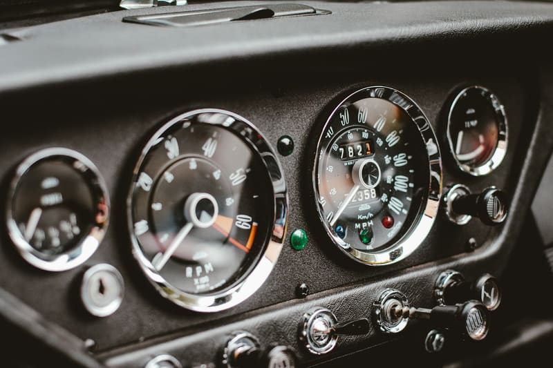 An instrument cluster with chrome-bezeled dials and toggle switches.